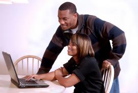 Man and woman looking at a computer
